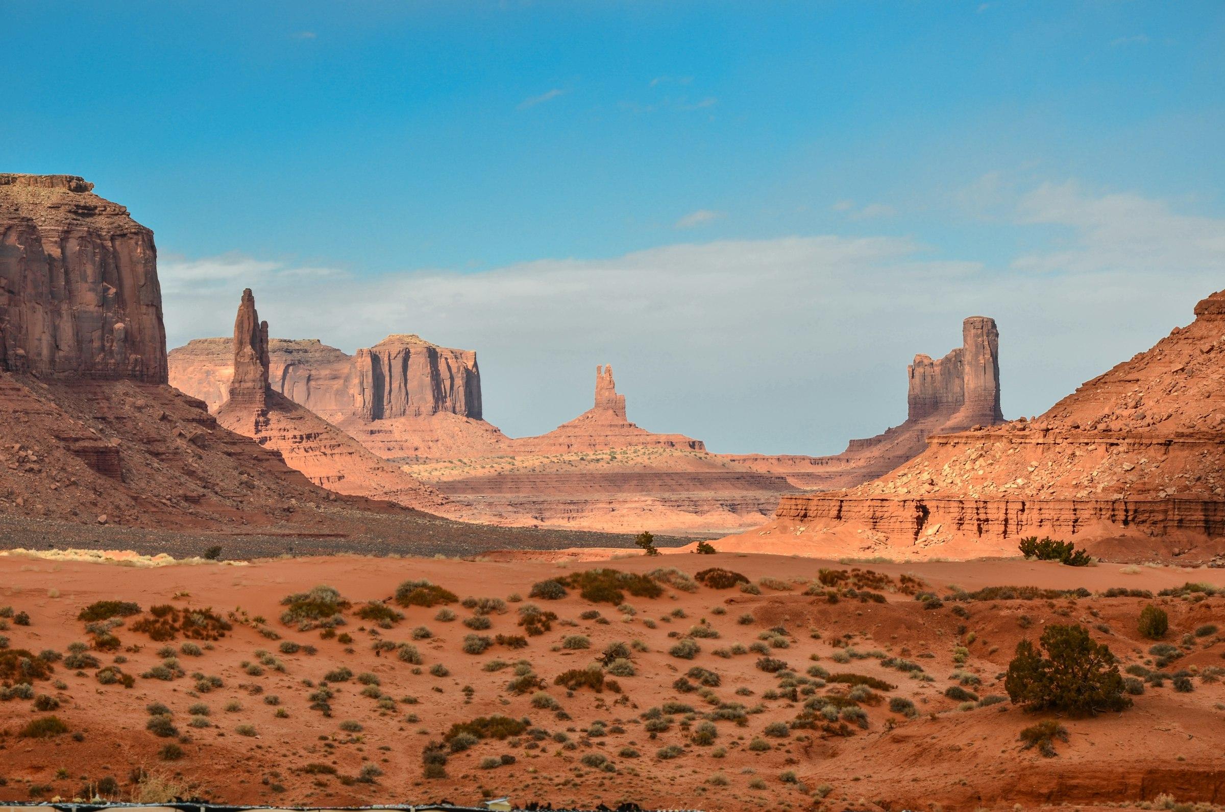 Open desert landscape with sandstone mesas and vacant land stretching to the horizon in the American Southwest